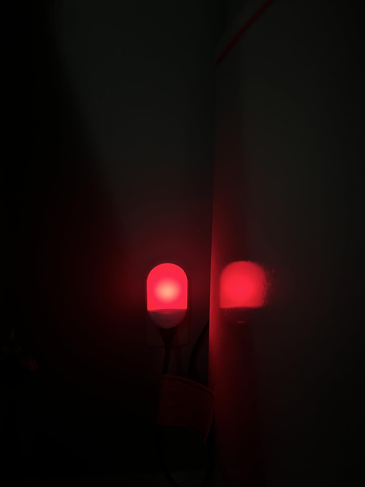 Finezeal 670nm plug-in red night light glowing in a dark room at night