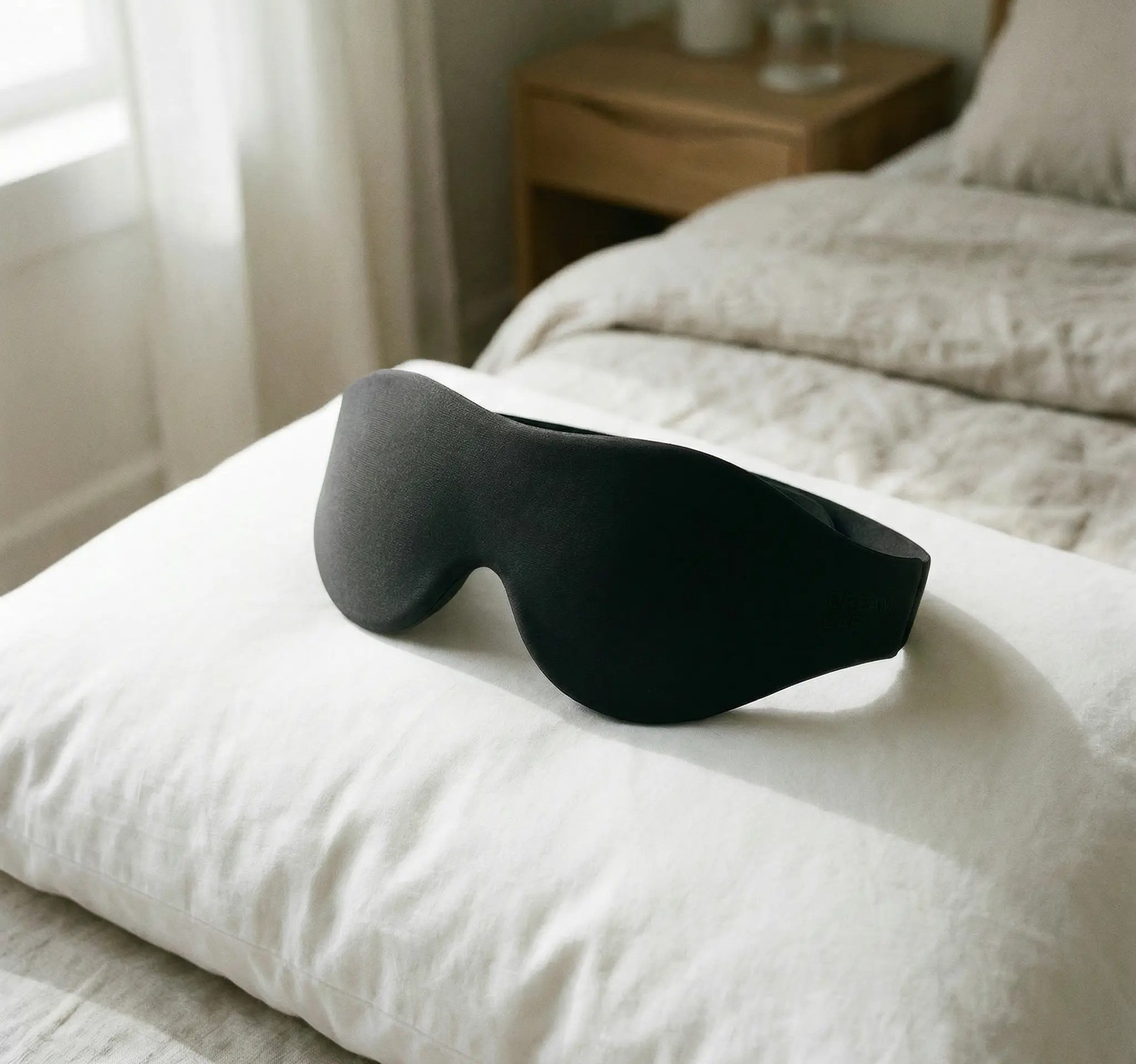 Contoured sleep mask for blocking light and protecting melatonin during sleep